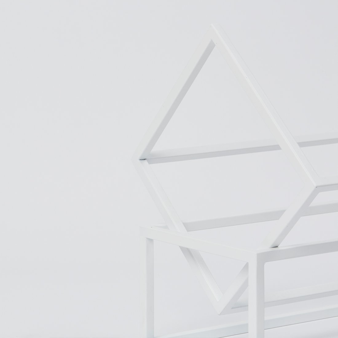 Elegant details from White Powder Coated Steel Book Keeper from Kristina Dam studio
